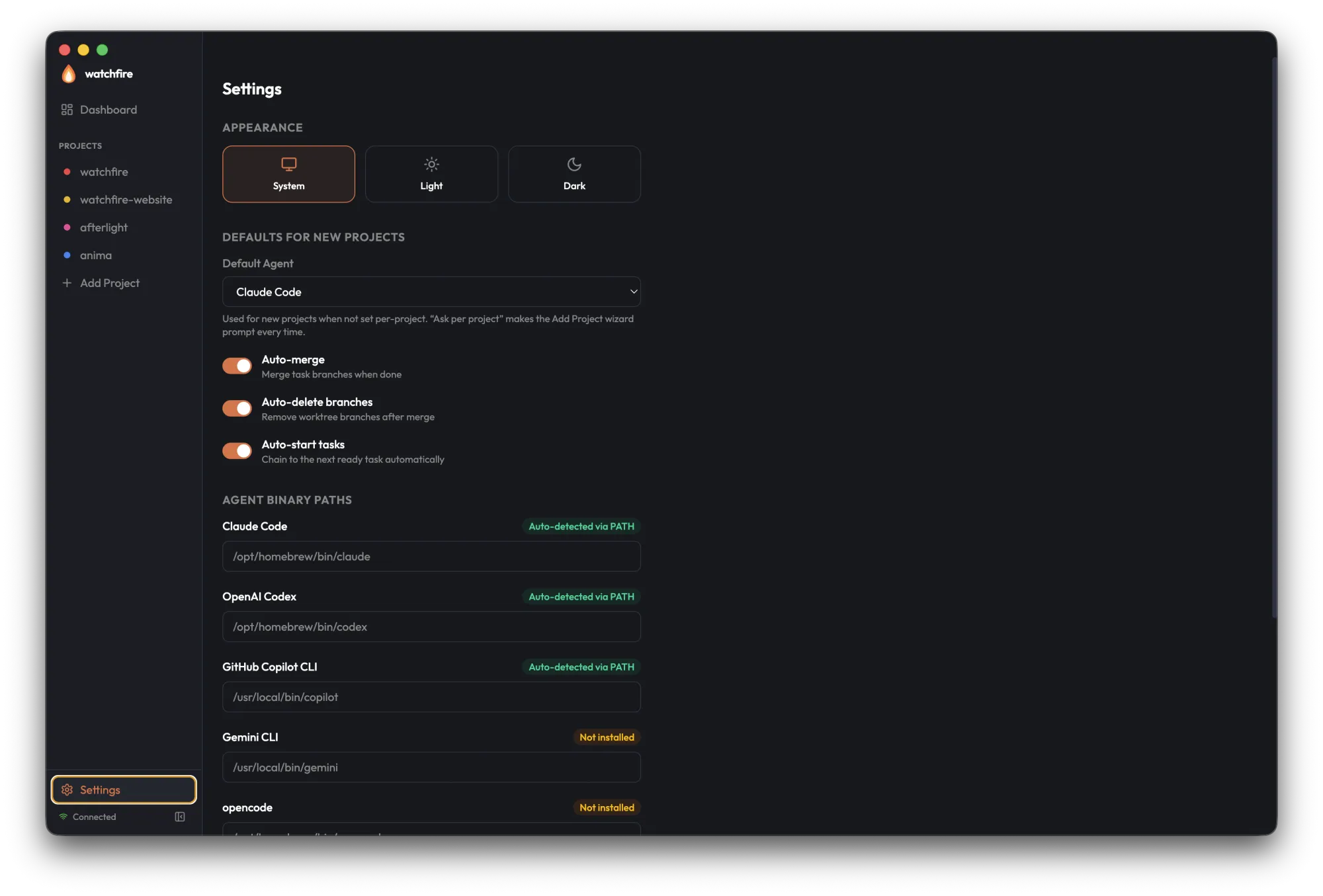 Global Settings showing Appearance theme picker, defaults for new projects, and agent binary paths with auto-detection status
